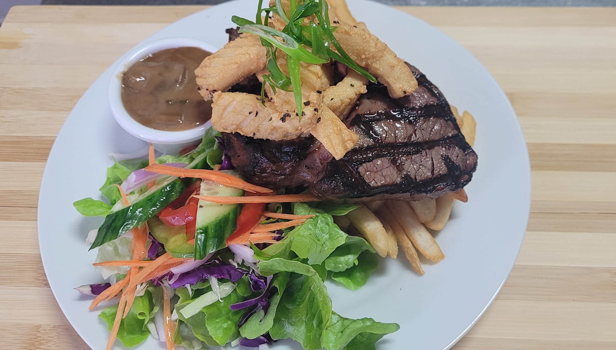 Juicy steak with chips and salad served at the Coominya Pub